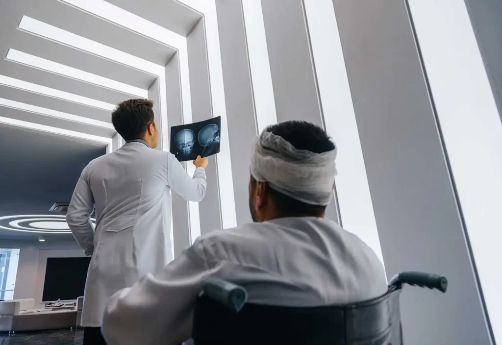 Patient-with-a-head-injury-and-doctor-looking-at-head-x-ray