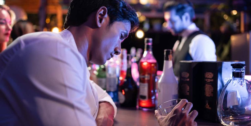 man overserved at bar and looking intoxicated