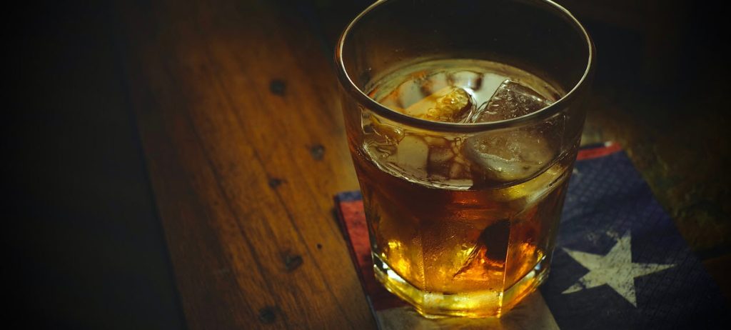 Whiskey in a glass on a texas flag coaster